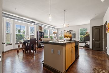 A kitchen with a large island in the middle of a living room